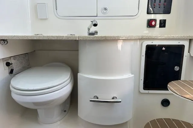 Slide: The Image of 2015 Regulator 34 boat interior with toilet, sink, and storage compartments. - 45