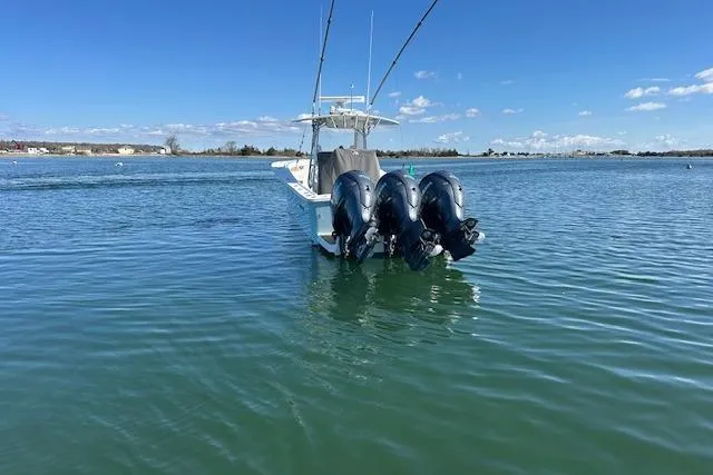 Slide: The Image of 2015 Regulator 34 boat with triple outboard engines on calm water. - 6