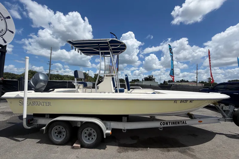 Slide: The Image of 2006 ShearWater 2200Z boat on trailer under cloudy sky. - 1