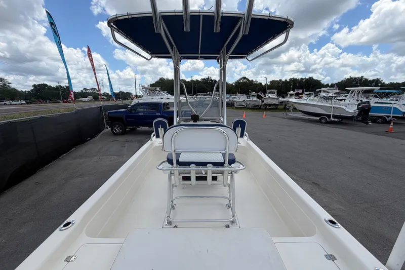 Slide: The Image of 2006 ShearWater 2200Z boat with T-top, parked in a marina under a cloudy sky. - 14