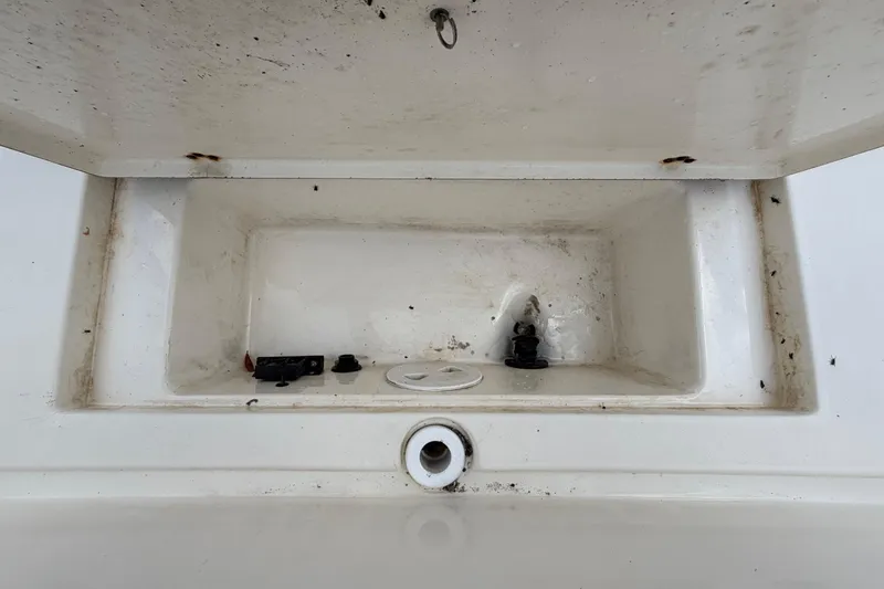 Slide: The Image of Open storage compartment in a 2006 ShearWater 2200Z boat, showing interior details. - 18