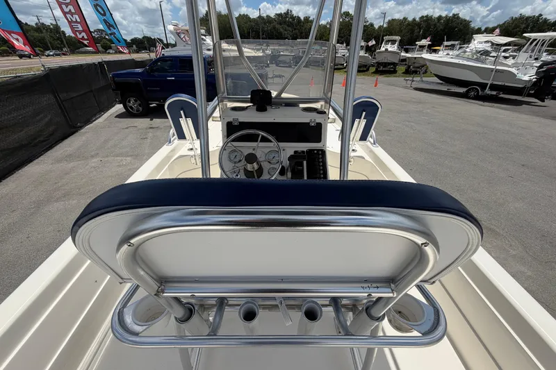 Slide: The Image of 2006 ShearWater 2200Z boat interior with steering wheel and seating, parked outdoors. - 19