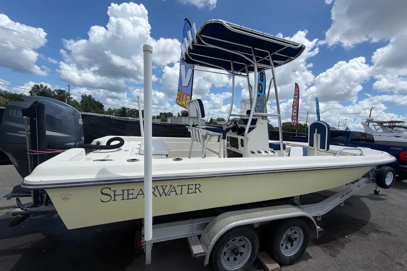 Slide: The Image of 2006 ShearWater 2200Z boat on trailer under blue sky with clouds. - 2