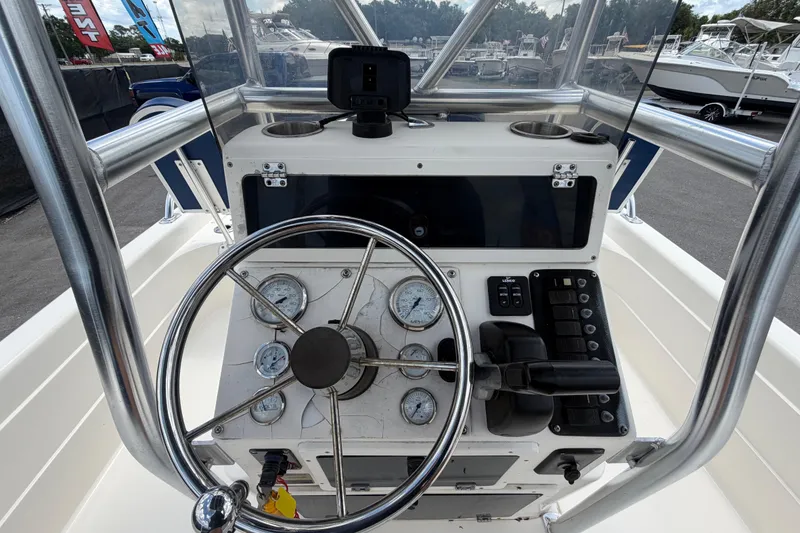 Slide: The Image of Steering console of a 2006 ShearWater 2200Z boat with gauges and controls. - 21