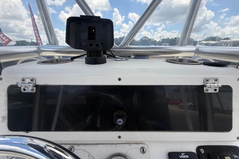 Slide: The Image of Console of a 2006 ShearWater 2200Z boat with mounted device and cup holders. - 24
