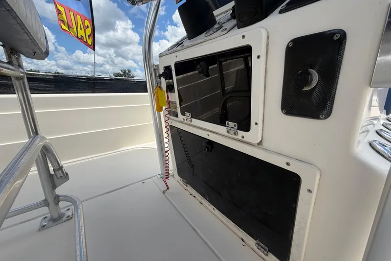 Slide: The Image of 2006 ShearWater 2200Z boat interior with control panel, for sale sign visible. - 26