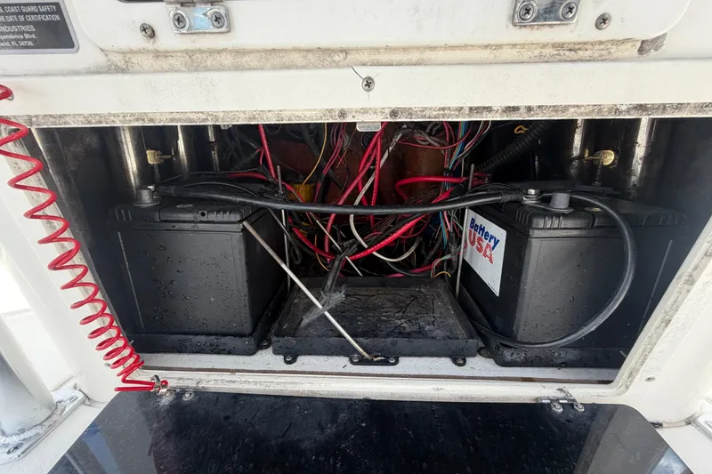 Slide: The Image of Battery compartment of a 2006 ShearWater 2200Z boat, featuring dual batteries and wiring. - 29