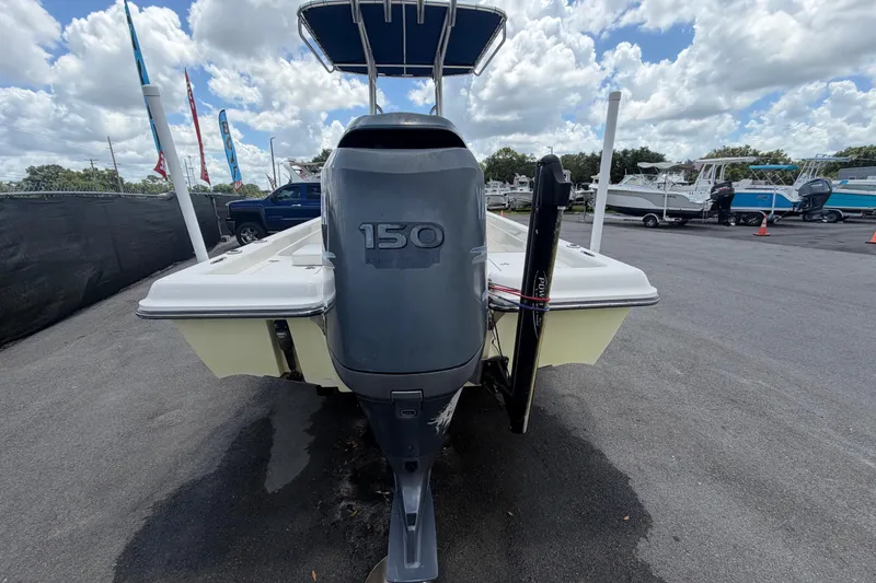 Slide: The Image of 2006 ShearWater 2200Z boat with 150 horsepower engine, parked outdoors under cloudy sky. - 3