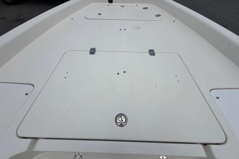 Slide: The Image of 2006 ShearWater 2200Z boat deck with storage compartments and latch. - 37