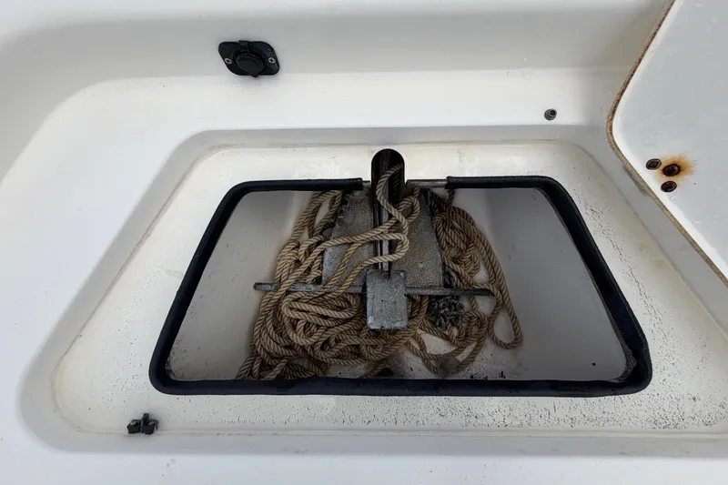 Slide: The Image of Anchor storage compartment on a 2006 ShearWater 2200Z boat, featuring coiled rope. - 40