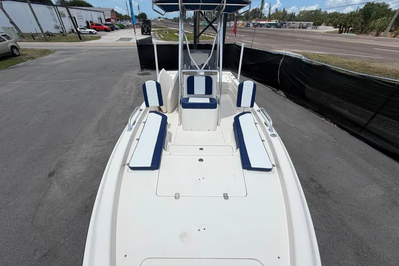 Slide: The Image of 2006 ShearWater 2200Z boat with blue and white seating, parked on a paved area. - 41