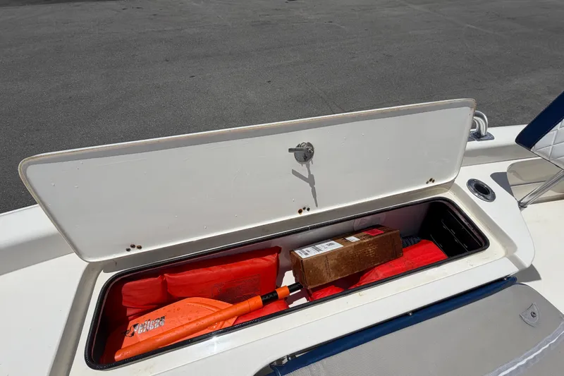 Slide: The Image of Open storage compartment on 2006 ShearWater 2200Z boat with safety gear and equipment. - 46