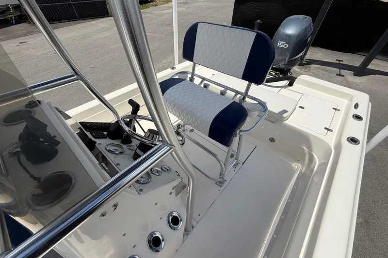 Slide: The Image of 2006 ShearWater 2200Z boat interior with steering console and Yamaha 150 engine. - 52