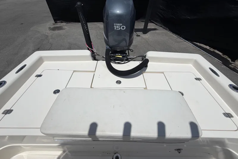 Slide: The Image of 2006 ShearWater 2200Z boat with Yamaha 150 engine, featuring spacious deck layout. - 56