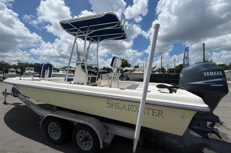 Slide: The Image of 2006 ShearWater 2200Z boat with Yamaha engine on trailer under cloudy sky. - 7