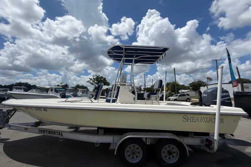 Slide: The Image of 2006 ShearWater 2200Z boat on trailer under cloudy sky. - 8