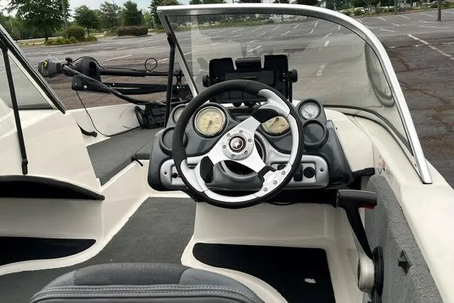 Slide: The Image of Interior view of a 2008 Stratos 476 Ski-N-Fish boat with steering console. - 2
