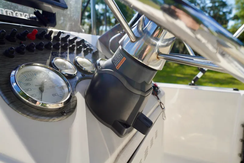 Slide: The Image of Close-up of 2023 Carolina Skiff 178 JLS boat dashboard with gauges and steering wheel. - 13