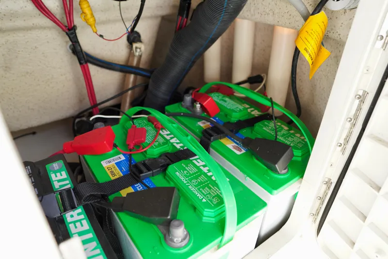 Slide: The Image of 2023 Carolina Skiff 178 JLS boat battery compartment with green Interstate batteries. - 15