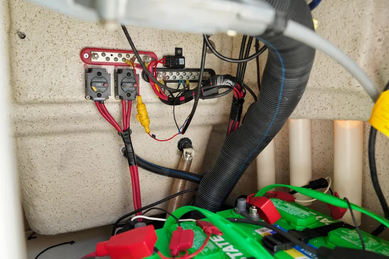 Slide: The Image of Electrical wiring and battery setup in a 2023 Carolina Skiff 178 JLS boat. - 16