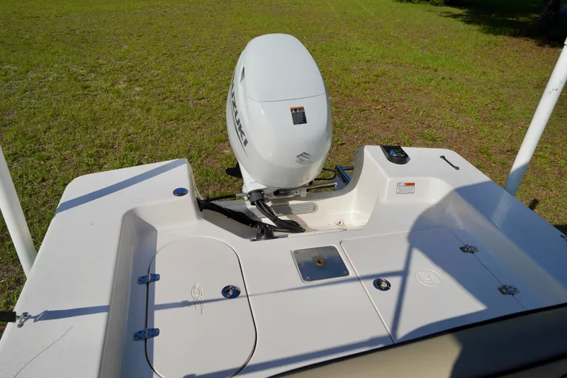 Slide: The Image of 2023 Carolina Skiff 178 JLS boat with Suzuki outboard motor, viewed from the rear. - 19