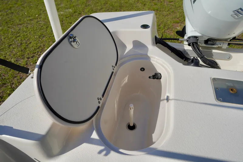 Slide: The Image of 2023 Carolina Skiff 178 JLS boat livewell with open lid, showcasing interior features. - 20