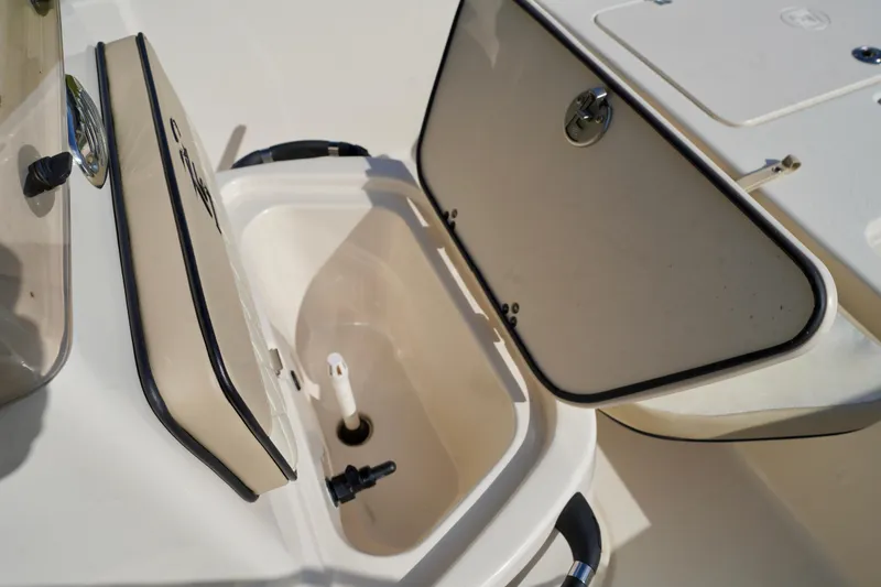 Slide: The Image of 2023 Carolina Skiff 178 JLS boat storage compartment with open hatch. - 7