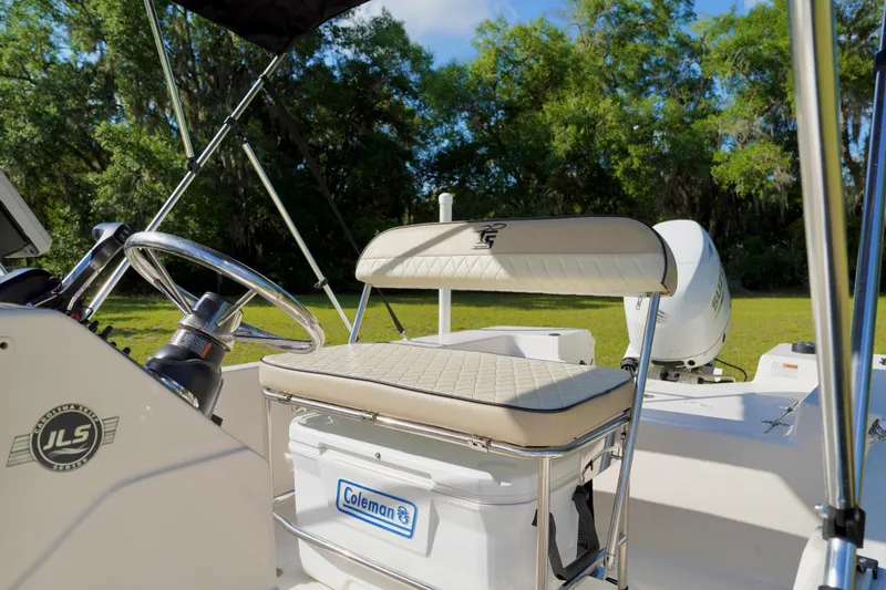 Slide: The Image of 2023 Carolina Skiff 178 JLS boat interior with steering wheel and seating. - 9