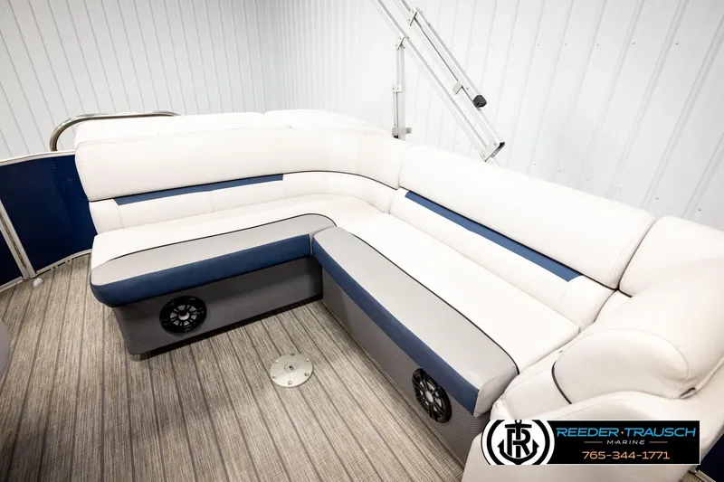Slide: The Image of 2022 Godfrey Sweetwater 2286 boat interior with white and blue seating, wood-style flooring. - 21