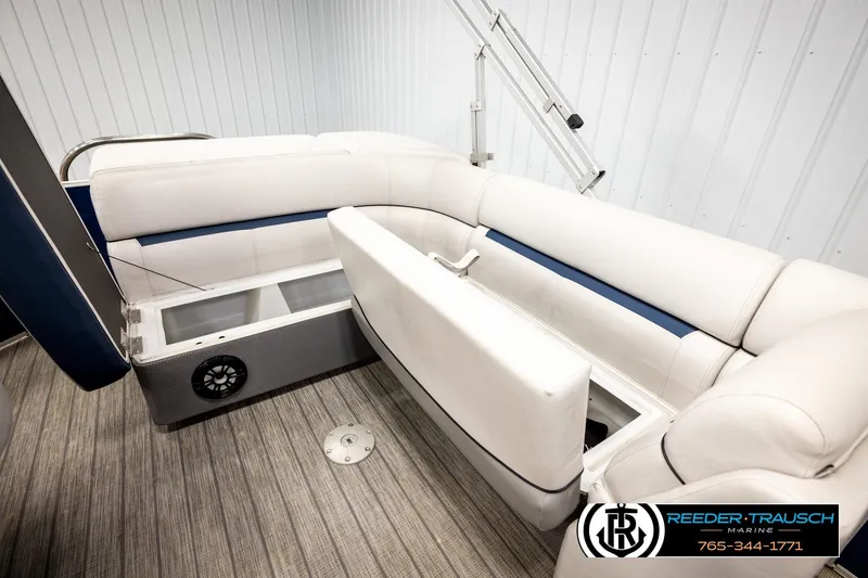 Slide: The Image of 2022 Godfrey Sweetwater 2286 boat interior with white seating and storage compartments. - 23