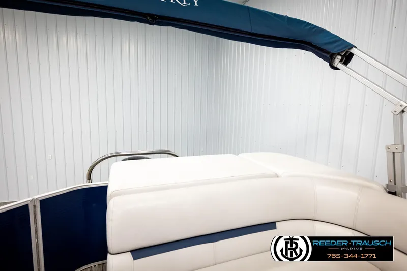 Slide: The Image of 2022 Godfrey Sweetwater 2286 boat interior with white seating and blue canopy. - 24