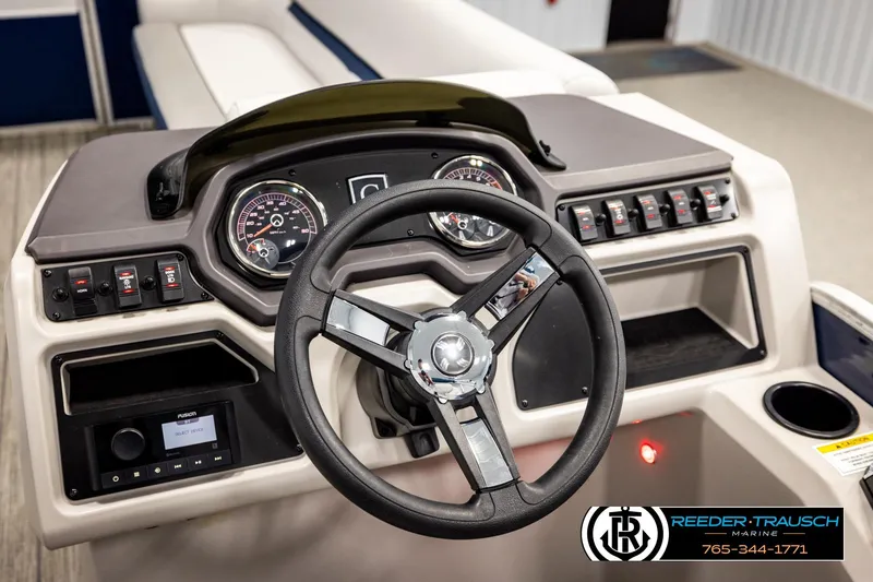 Slide: The Image of 2022 Godfrey Sweetwater 2286 boat dashboard with steering wheel and control panel. - 29