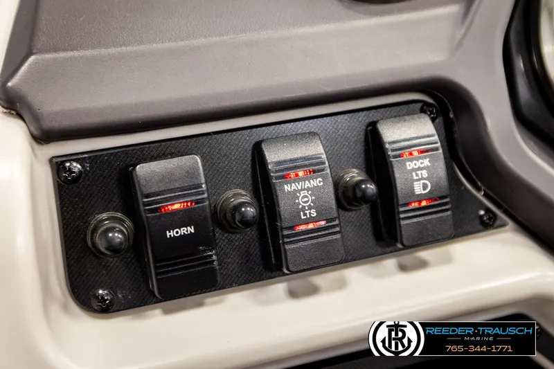 Slide: The Image of Control panel of 2022 Godfrey Sweetwater 2286 with horn, navigation, and dock light switches. - 32