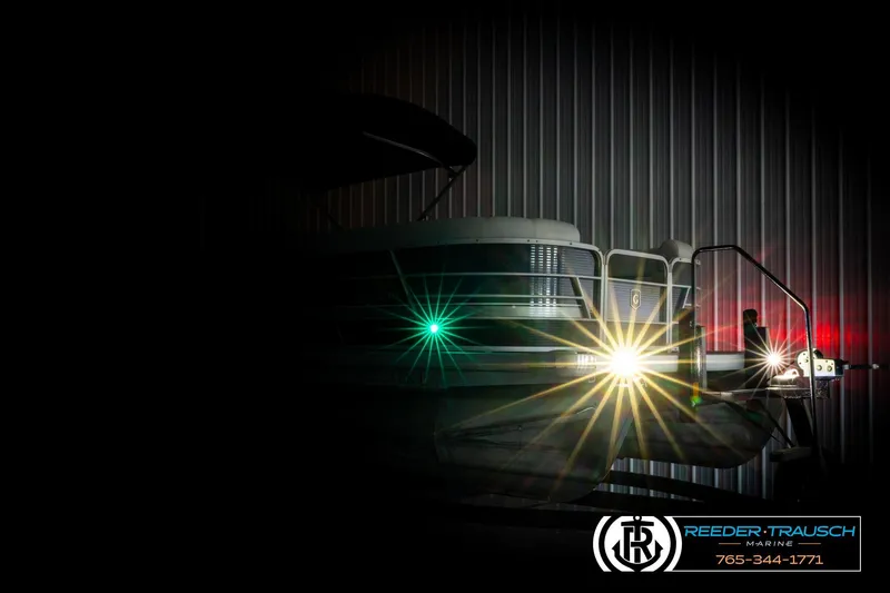 Slide: The Image of 2022 Godfrey Sweetwater 2286 pontoon boat with bright lights in a dimly lit setting. - 4