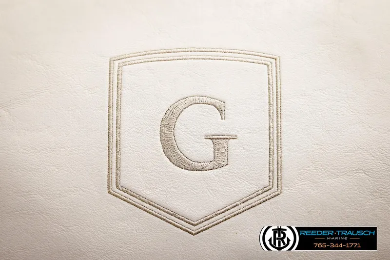 Slide: The Image of Godfrey Sweetwater 2286 2022 logo on white leather upholstery, Reeder-Trausch Marine branding. - 41