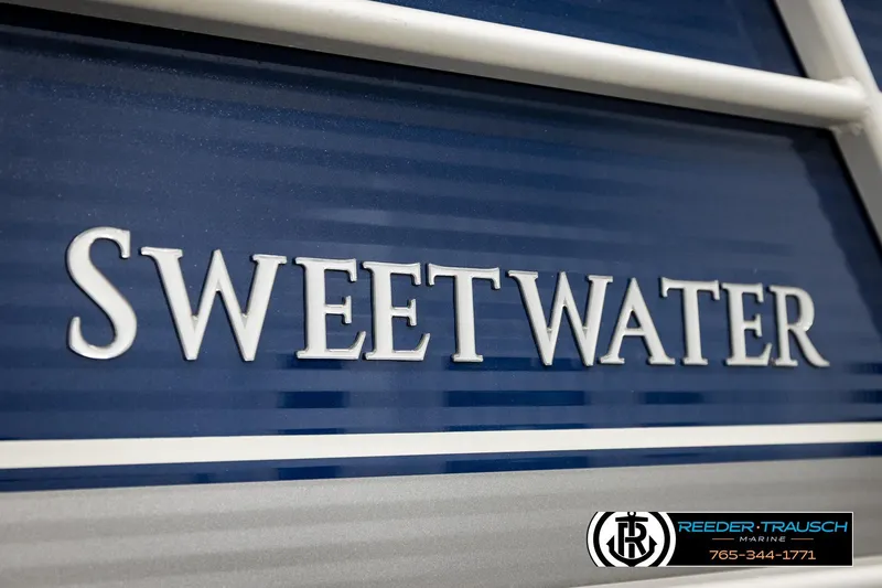 Slide: The Image of Close-up of 2022 Godfrey Sweetwater 2286 boat nameplate with Reeder-Trausch Marine logo. - 50