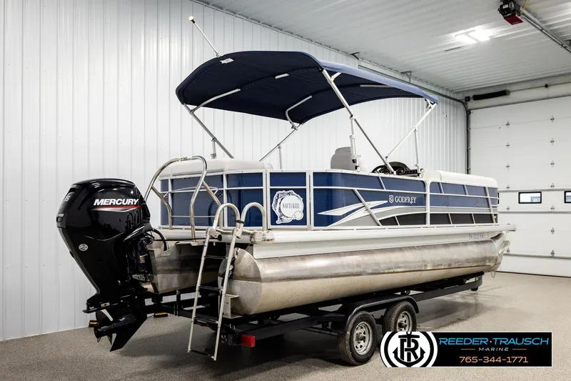 Slide: The Image of 2022 Godfrey Sweetwater 2286 pontoon boat with Mercury engine in a showroom. - 6