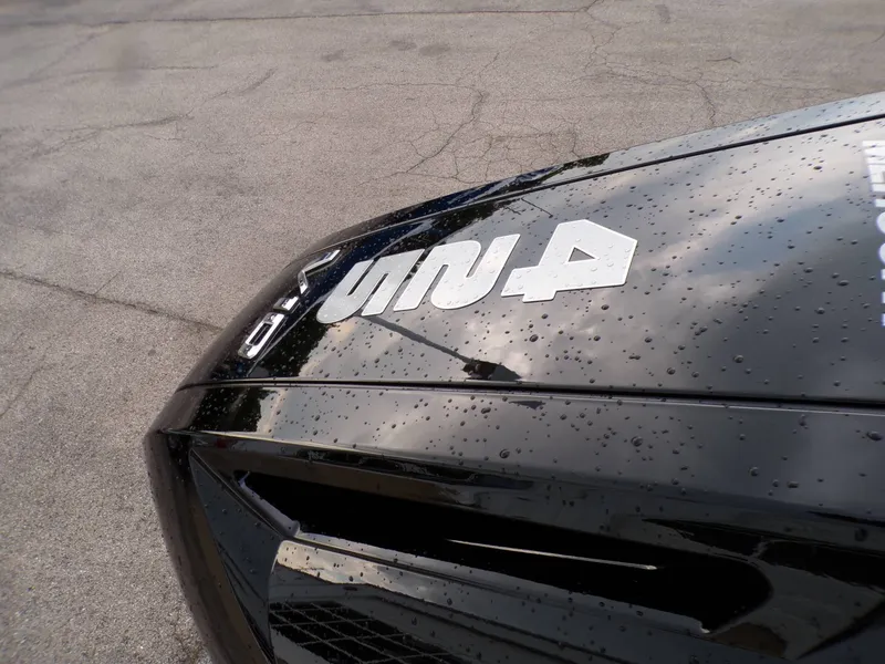 Slide: The Image of Close-up of a shiny black vehicle with water droplets. - 9