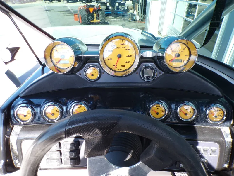 Slide: The Image of Dashboard of a 2005 MasterCraft X-80 boat with yellow gauges. - 10