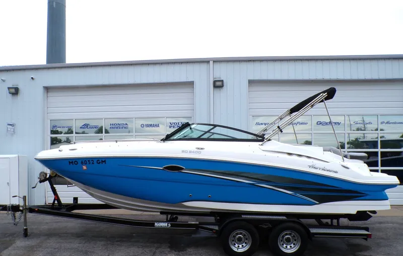 The Image of 2018 Hurricane 2400 SD boat on trailer in front of garage. - 1