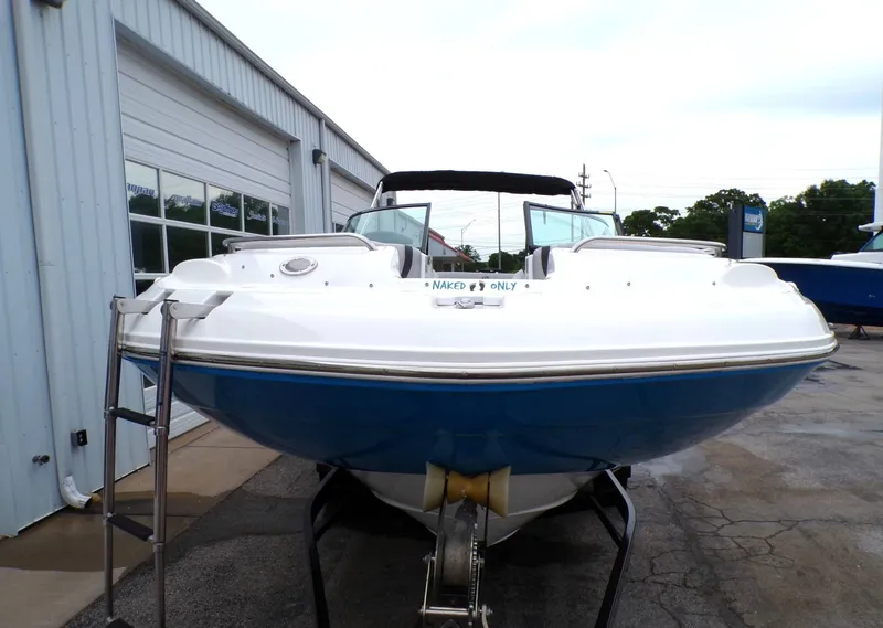 Slide: The Image of 2018 Hurricane 2400 SD boat in front of warehouse. - 4