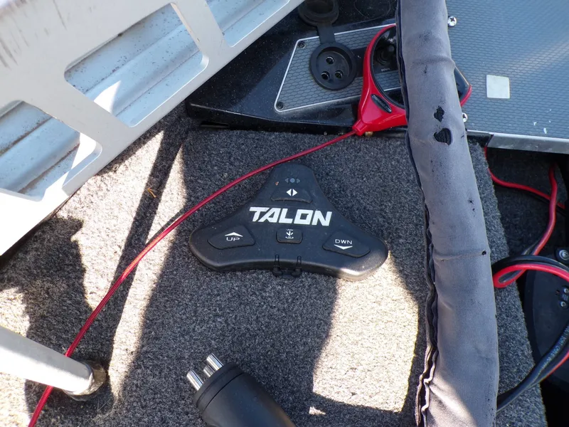 Slide: The Image of Talon remote on the floor of a Lund 2075 Pro V Bass XS boat. - 22