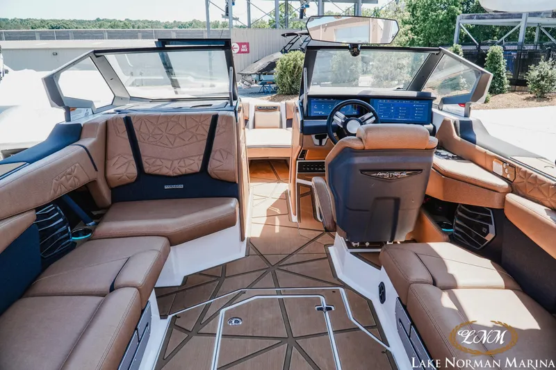 Slide: The Image of 2024 Nautique Super Air Nautique G25 Paragon interior with luxurious seating and advanced dashboard. - 14