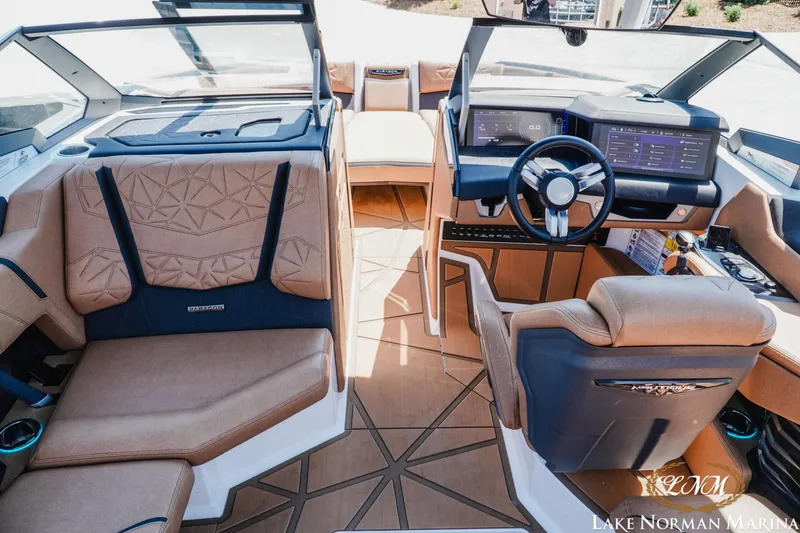 Slide: The Image of 2024 Nautique Super Air Nautique G25 Paragon interior with luxurious seating and advanced dashboard. - 18