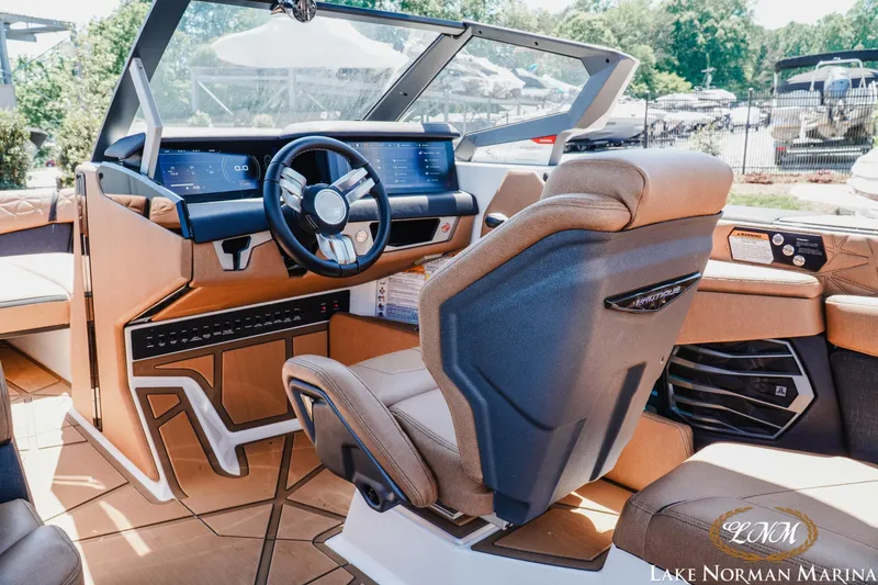 Slide: The Image of 2024 Nautique Super Air Nautique G25 Paragon cockpit with modern controls and luxurious seating. - 19