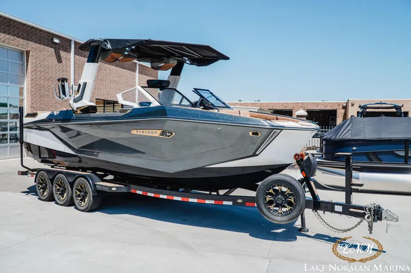 Slide: The Image of 2024 Nautique Super Air Nautique G25 Paragon boat on trailer at Lake Norman Marina. - 2