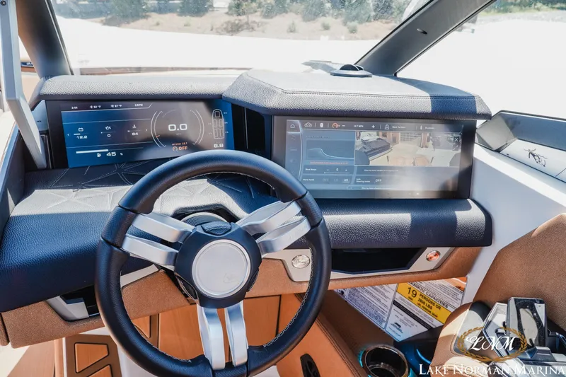 Slide: The Image of 2024 Nautique Super Air Nautique G25 Paragon dashboard with advanced digital displays and steering wheel. - 26