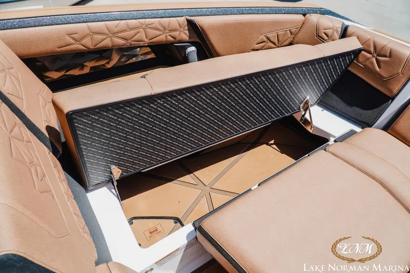 Slide: The Image of 2024 Nautique Super Air Nautique G25 Paragon interior storage compartment, featuring luxurious tan upholstery. - 28