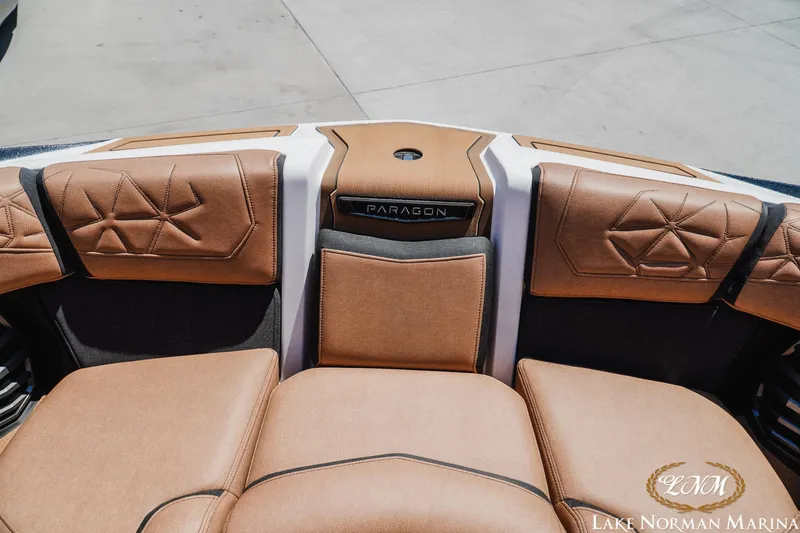 Slide: The Image of 2024 Nautique Super Air Nautique G25 Paragon interior with luxurious brown seating. - 29