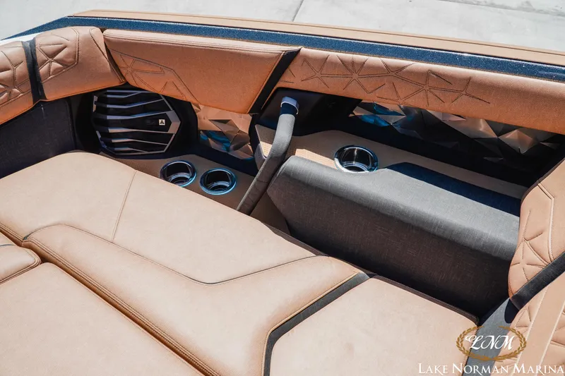 Slide: The Image of 2024 Nautique Super Air Nautique G25 Paragon interior with luxurious seating and cup holders. - 30